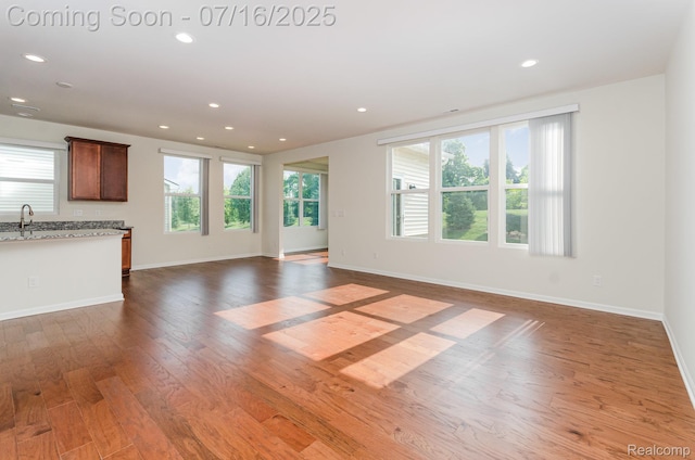 4000 Ashdale Way, Clarkston, MI 48348 - unfurnished living room featuring wood finished floors, plenty of natural light, and recessed lighting