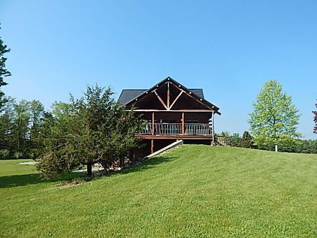 8475 Gurd Rd, Dowling, MI 49050 - rear view of property featuring a yard and a wooden deck