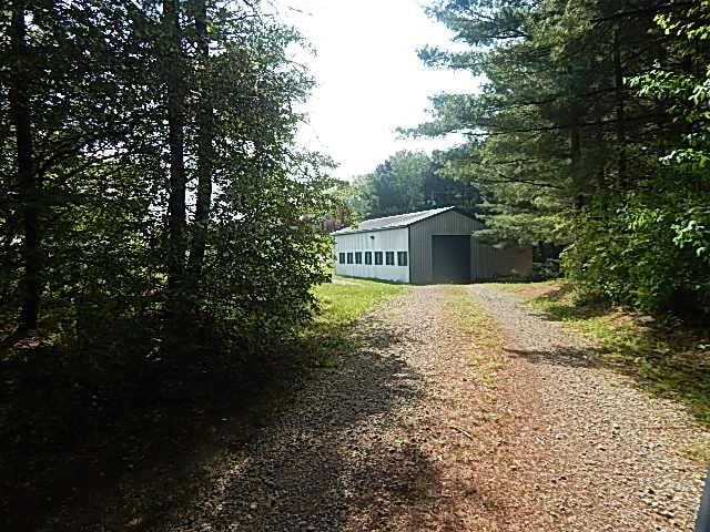 8475 Gurd Rd, Dowling, MI 49050 - view of home's exterior featuring driveway and an outbuilding
