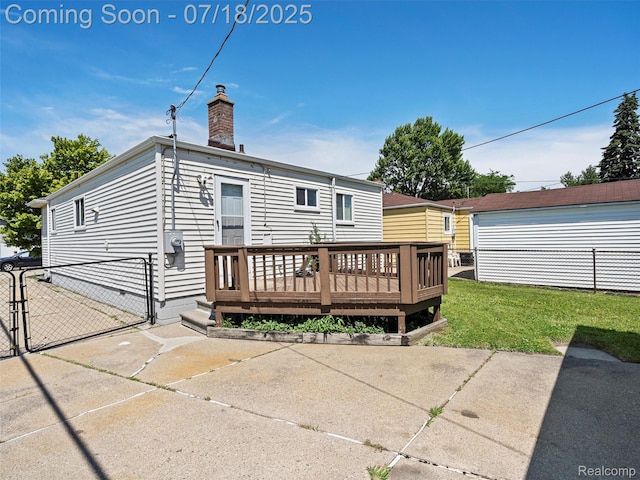 27034 Baldwin Ave, Warren, MI 48092 - rear view of property featuring a gate, a wooden deck, and a chimney