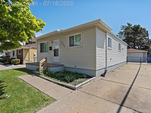 27034 Baldwin Ave, Warren, MI 48092 - view of front of property featuring a detached garage, a front yard, and an outbuilding