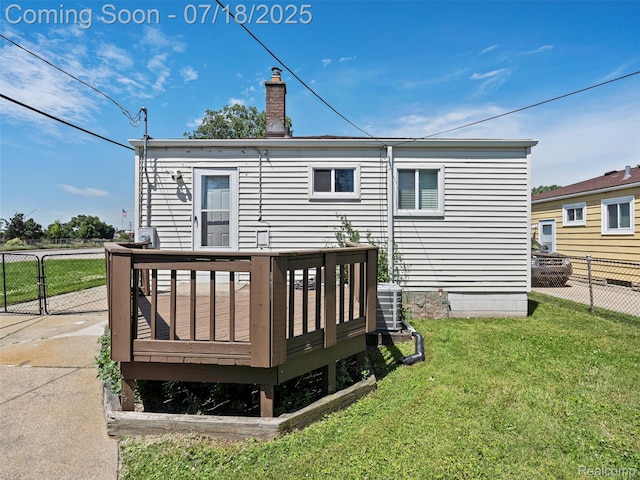 27034 Baldwin Ave, Warren, MI 48092 - rear view of house with a wooden deck and a chimney
