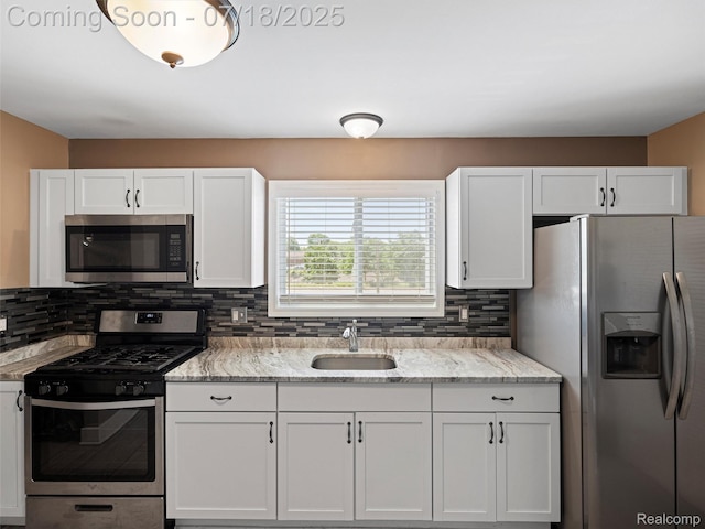 27034 Baldwin Ave, Warren, MI 48092 - kitchen featuring appliances with stainless steel finishes, white cabinets, and decorative backsplash
