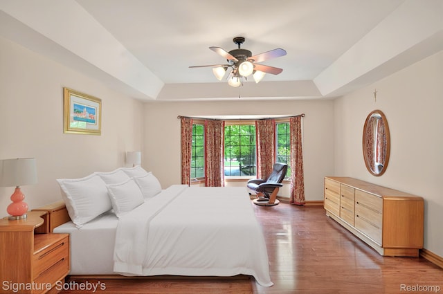 40600 8 Mile Rd, Northville, MI 48167 - bedroom featuring a tray ceiling, wood finished floors, and ceiling fan