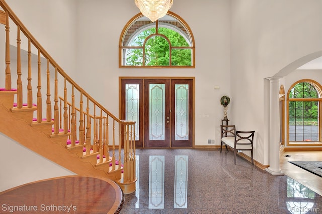 40600 8 Mile Rd, Northville, MI 48167 - foyer featuring a high ceiling, granite floors, arched walkways, stairs, and ornate columns