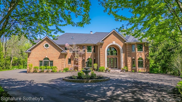 40600 8 Mile Rd, Northville, MI 48167 - view of front of house featuring brick siding and curved driveway