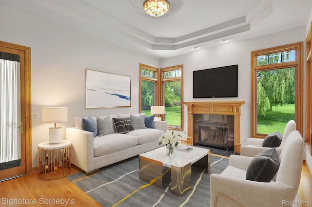 40600 8 Mile Rd, Northville, MI 48167 - living room with wood finished floors, plenty of natural light, a raised ceiling, and a tile fireplace