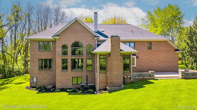 40600 8 Mile Rd, Northville, MI 48167 - back of property with a chimney, a lawn, and brick siding