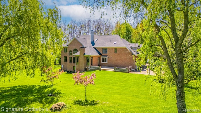 40600 8 Mile Rd, Northville, MI 48167 - back of house featuring a lawn and brick siding