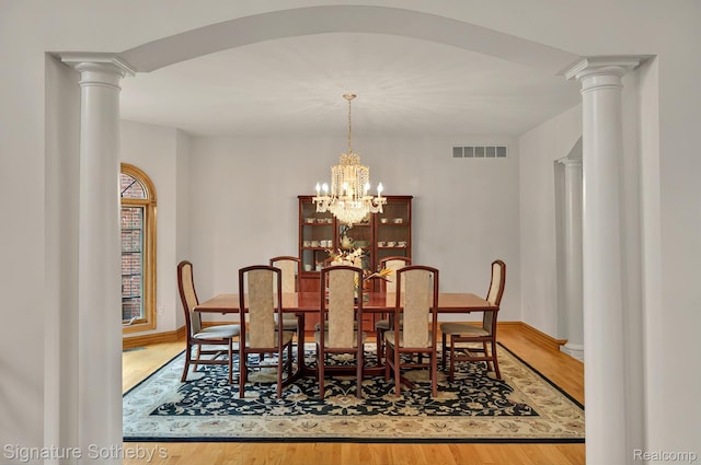 40600 8 Mile Rd, Northville, MI 48167 - dining area with wood finished floors, a chandelier, and ornate columns