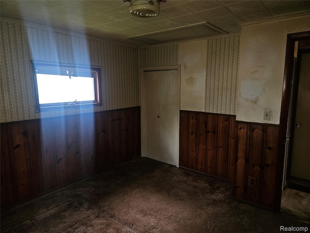 1081 W Parkwood Ave, Flint, MI 48507 - carpeted spare room with wainscoting, wood walls, wallpapered walls, and crown molding