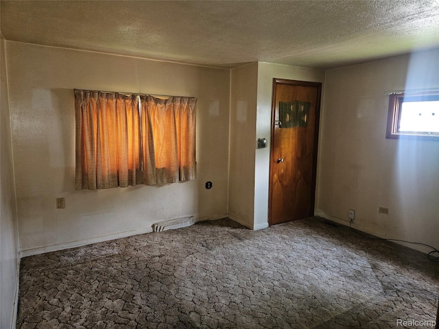 1081 W Parkwood Ave, Flint, MI 48507 - carpeted spare room with a textured ceiling and baseboards