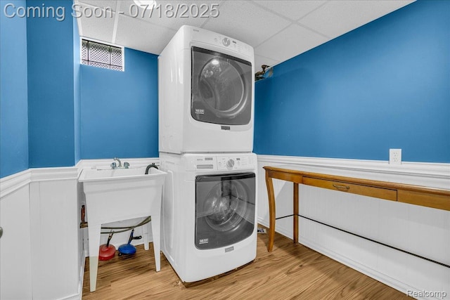 24429 Notre Dame St, Dearborn, MI 48124 - washroom featuring stacked washer and clothes dryer, wainscoting, and wood finished floors
