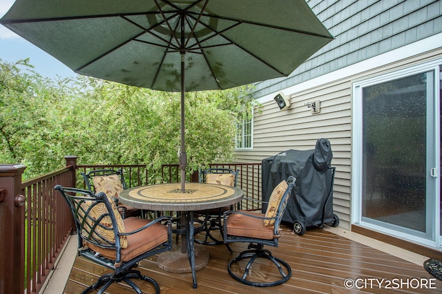 3981 Acadia Dr, Hudsonville, MI 49426 - wooden deck with outdoor dining area and a grill