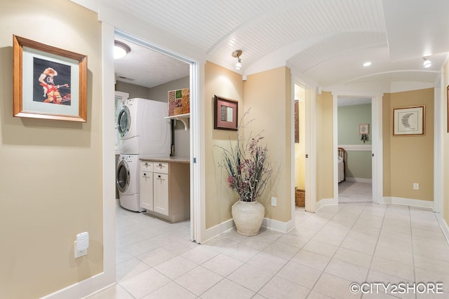 3981 Acadia Dr, Hudsonville, MI 49426 - corridor with stacked washing machine and dryer and light tile patterned flooring