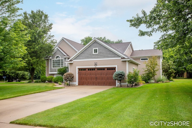 3981 Acadia Dr, Hudsonville, MI 49426 - view of front of property featuring a garage, a front lawn, and concrete driveway