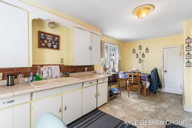 747 State St, Holland, MI 49423 - kitchen featuring light countertops, decorative backsplash, and white cabinets