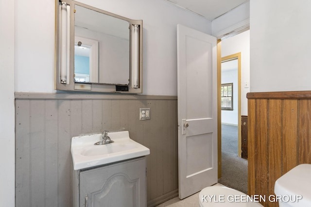 747 State St, Holland, MI 49423 - bathroom featuring vanity, wainscoting, and wood walls