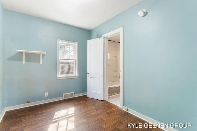 747 State St, Holland, MI 49423 - unfurnished bedroom featuring wood finished floors and connected bathroom