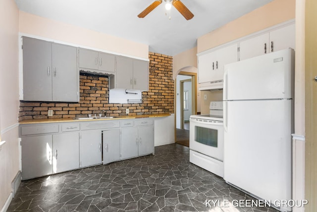 747 State St, Holland, MI 49423 - kitchen featuring white appliances, under cabinet range hood, ceiling fan, stone flooring, and gray cabinetry