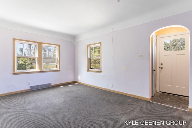 747 State St, Holland, MI 49423 - unfurnished room with arched walkways and carpet