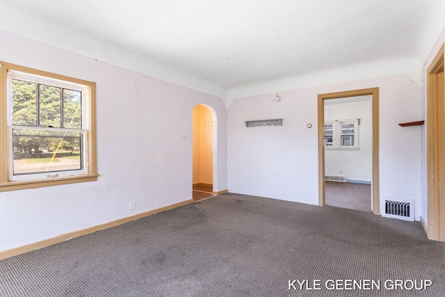 747 State St, Holland, MI 49423 - spare room featuring carpet and arched walkways