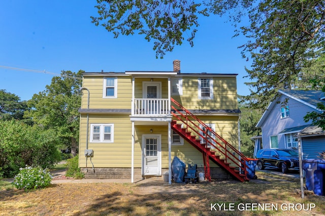 747 State St, Holland, MI 49423 - back of house featuring a chimney and stairs