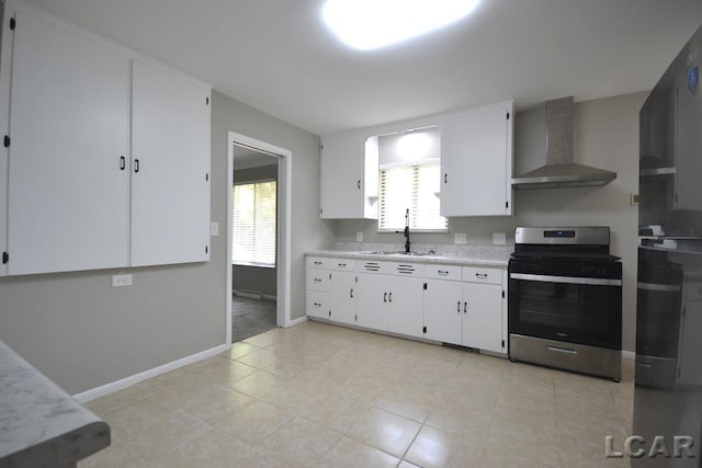304 N Van Buren St, Tecumseh, MI 49286 - kitchen with electric stove, wall chimney range hood, light countertops, and white cabinets