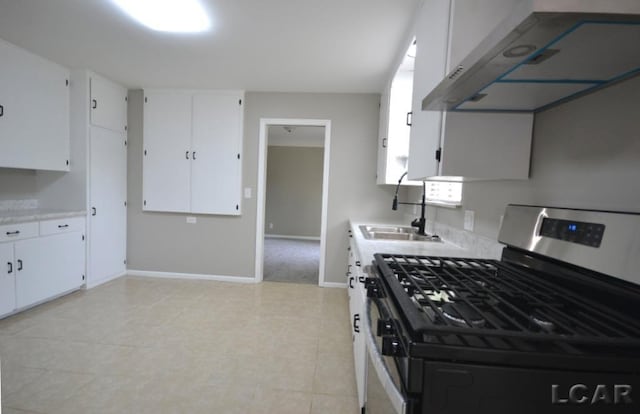 304 N Van Buren St, Tecumseh, MI 49286 - kitchen featuring stainless steel gas range oven, range hood, light countertops, and white cabinetry