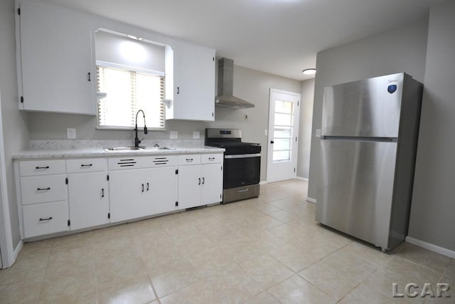 304 N Van Buren St, Tecumseh, MI 49286 - kitchen featuring appliances with stainless steel finishes, wall chimney range hood, light countertops, white cabinetry, and light tile patterned floors