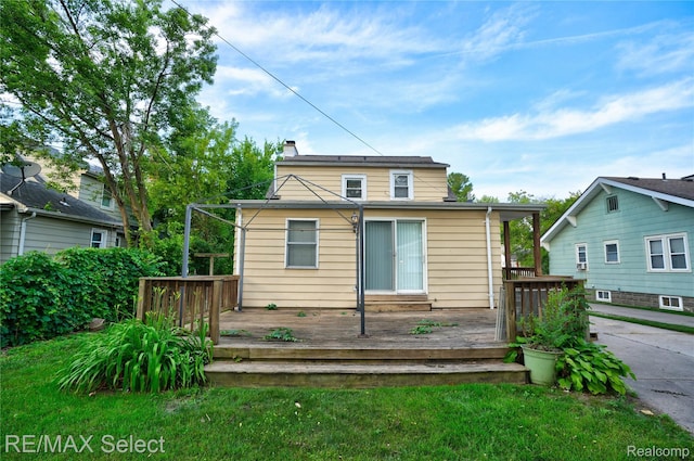 619 Frank St, Flint, MI 48504 - back of property with a chimney, a deck, and a lawn