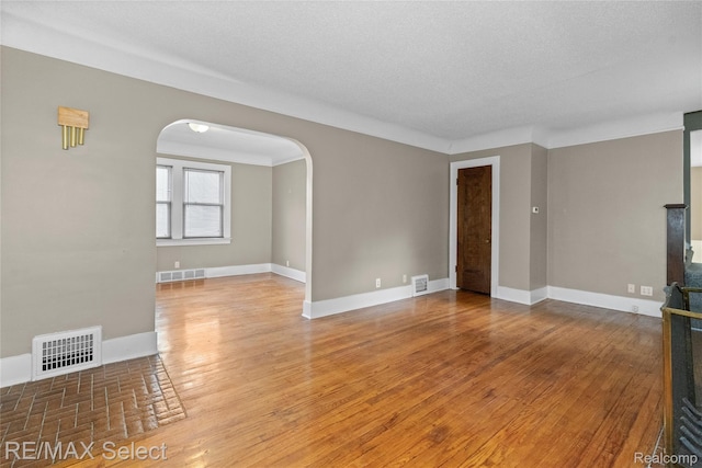 619 Frank St, Flint, MI 48504 - unfurnished living room with arched walkways and wood finished floors