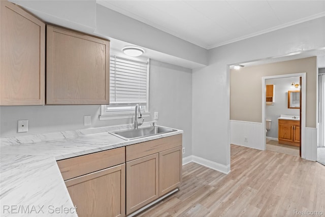 619 Frank St, Flint, MI 48504 - kitchen featuring light countertops, crown molding, light wood-style flooring, wainscoting, and light brown cabinets