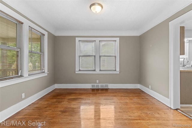 619 Frank St, Flint, MI 48504 - spare room with light wood finished floors and baseboards