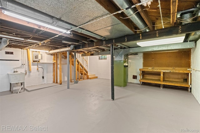 619 Frank St, Flint, MI 48504 - unfinished below grade area with stairway, heating unit, and concrete block wall