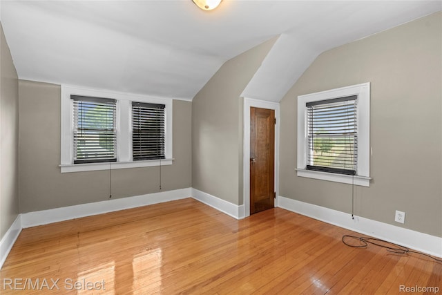 619 Frank St, Flint, MI 48504 - unfurnished room with healthy amount of natural light, light wood-style flooring, and lofted ceiling