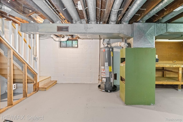 619 Frank St, Flint, MI 48504 - unfinished basement featuring heating unit, stairs, and gas water heater