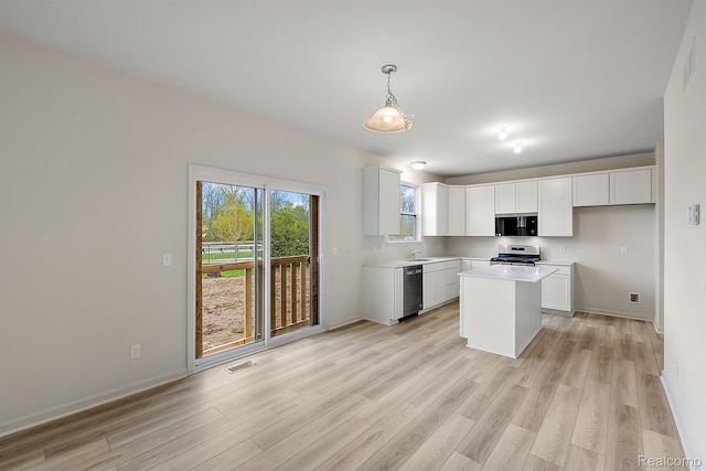21008 Campolina Dr, South Lyon, MI 48178 - kitchen featuring appliances with stainless steel finishes, light wood-style floors, light countertops, and white cabinets