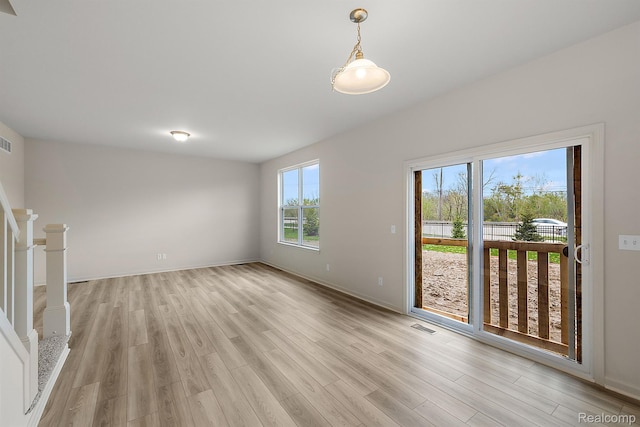 21008 Campolina Dr, South Lyon, MI 48178 - unfurnished living room with light wood-type flooring and baseboards