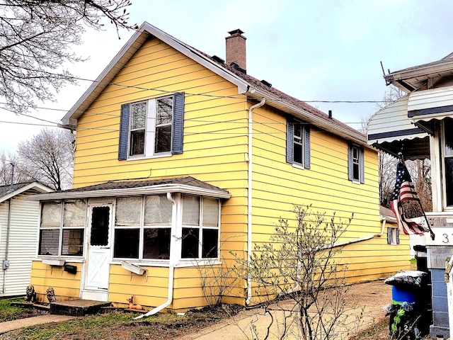 313 Taylor St, Jackson, MI 49202 - view of side of property with a chimney