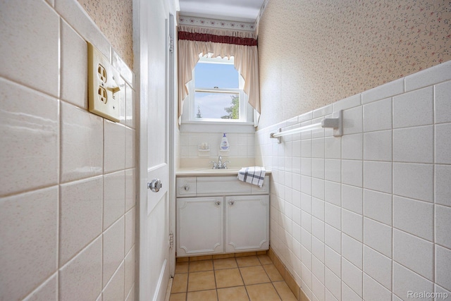 1615 W Genesee St, Lapeer, MI 48446 - bathroom with wallpapered walls, vanity, tile walls, and tile patterned flooring
