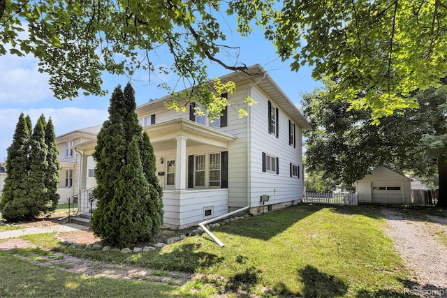 1615 W Genesee St, Lapeer, MI 48446 - view of side of home featuring driveway, an outbuilding, a garage, and covered porch