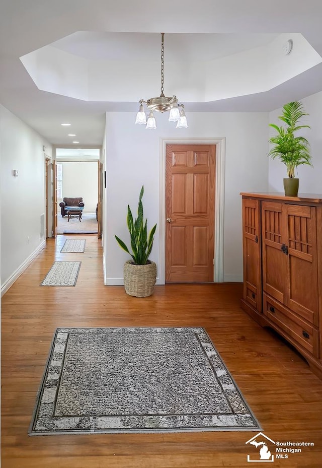 8 E Front St, Monroe, MI 48161 - entryway featuring wood finished floors, a chandelier, and a raised ceiling