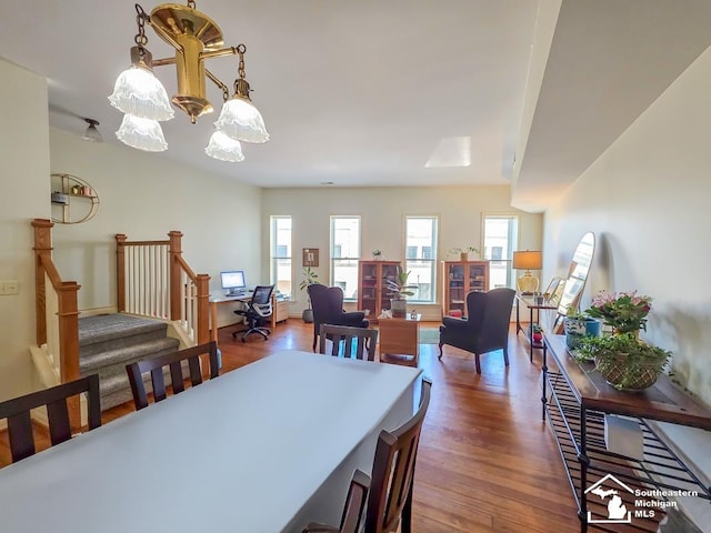 8 E Front St, Monroe, MI 48161 - dining area featuring wood finished floors, a chandelier, and stairs