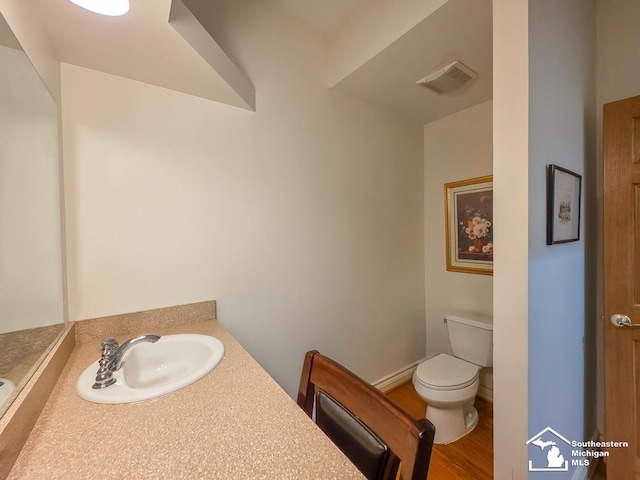 8 E Front St, Monroe, MI 48161 - half bath featuring vanity and wood finished floors