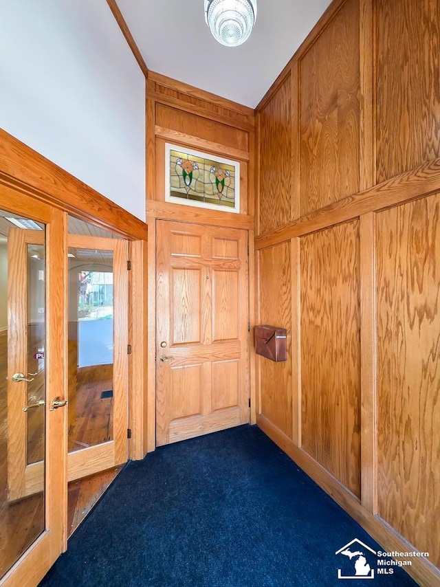 8 E Front St, Monroe, MI 48161 - foyer with dark colored carpet and wood walls