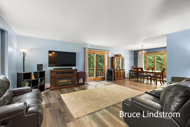 15520 157th Ave, Big Rapids, MI 49307 - living room with a chandelier, wood finished floors, and a baseboard heating unit