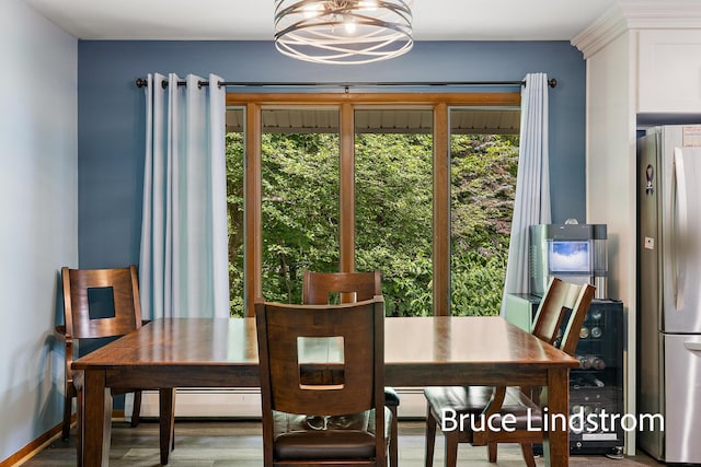 15520 157th Ave, Big Rapids, MI 49307 - dining space featuring baseboard heating, a chandelier, and wood finished floors