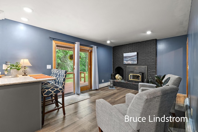 15520 157th Ave, Big Rapids, MI 49307 - living area featuring wood finished floors, a fireplace, a baseboard radiator, and recessed lighting