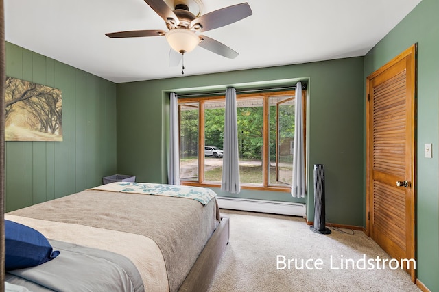15520 157th Ave, Big Rapids, MI 49307 - carpeted bedroom featuring a baseboard heating unit and a ceiling fan